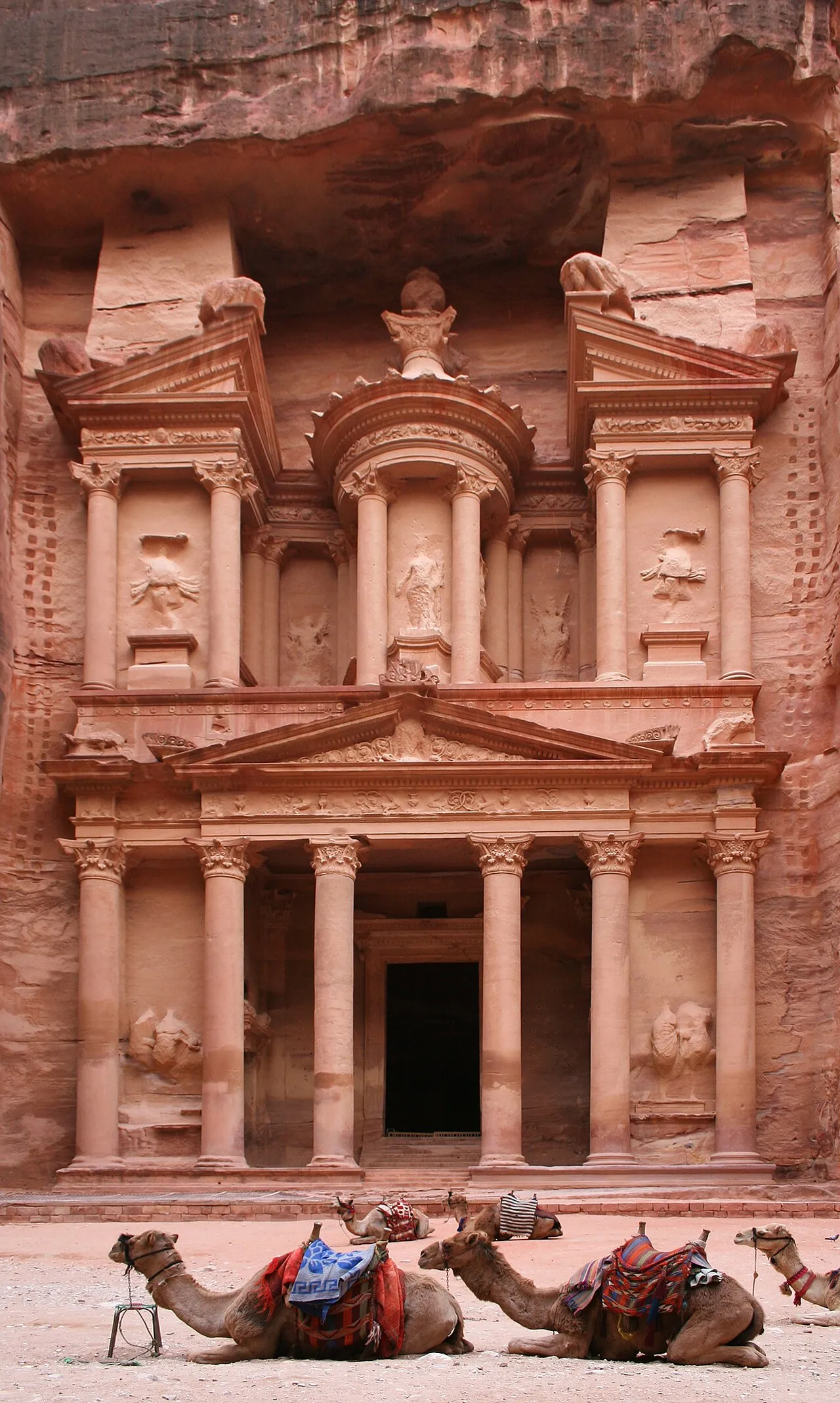 The Treasury facade carved into rose-red sandstone cliffs at Petra, Jordan