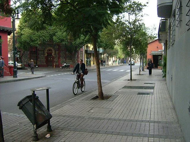 Street scene in Barrio Lastarria Santiago Chile with pedestrians walking past cafes and heritage buildings