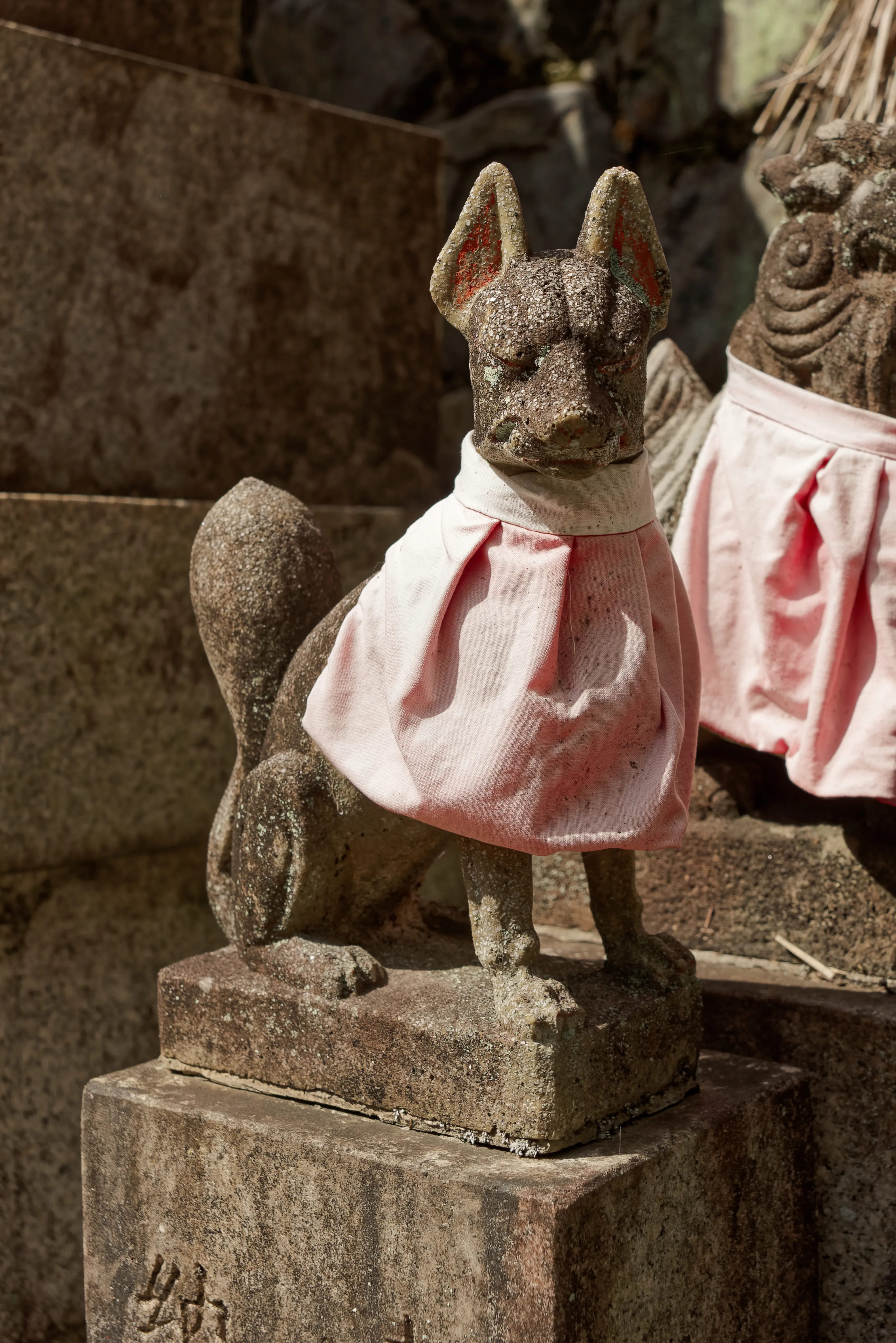 A stone fox guardian holding a key in its mouth at the Fushimi Inari shrine in Kyoto