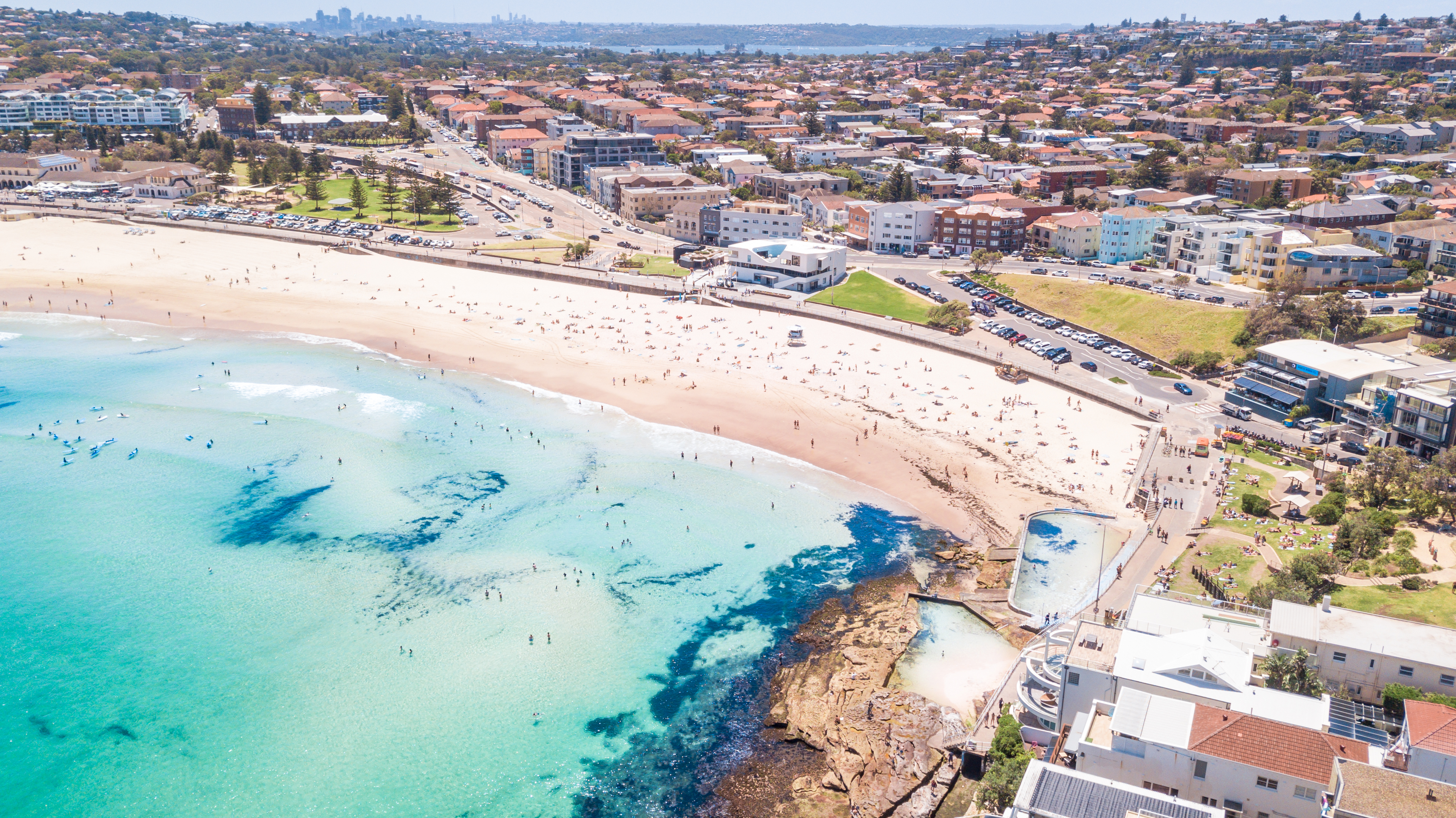 Bondi Beach in Sydney with golden sand and surf and the iconic coastal headlands