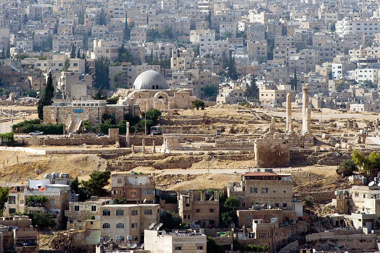 The Roman Temple of Hercules columns on the Amman Citadel hill with the modern city spread below