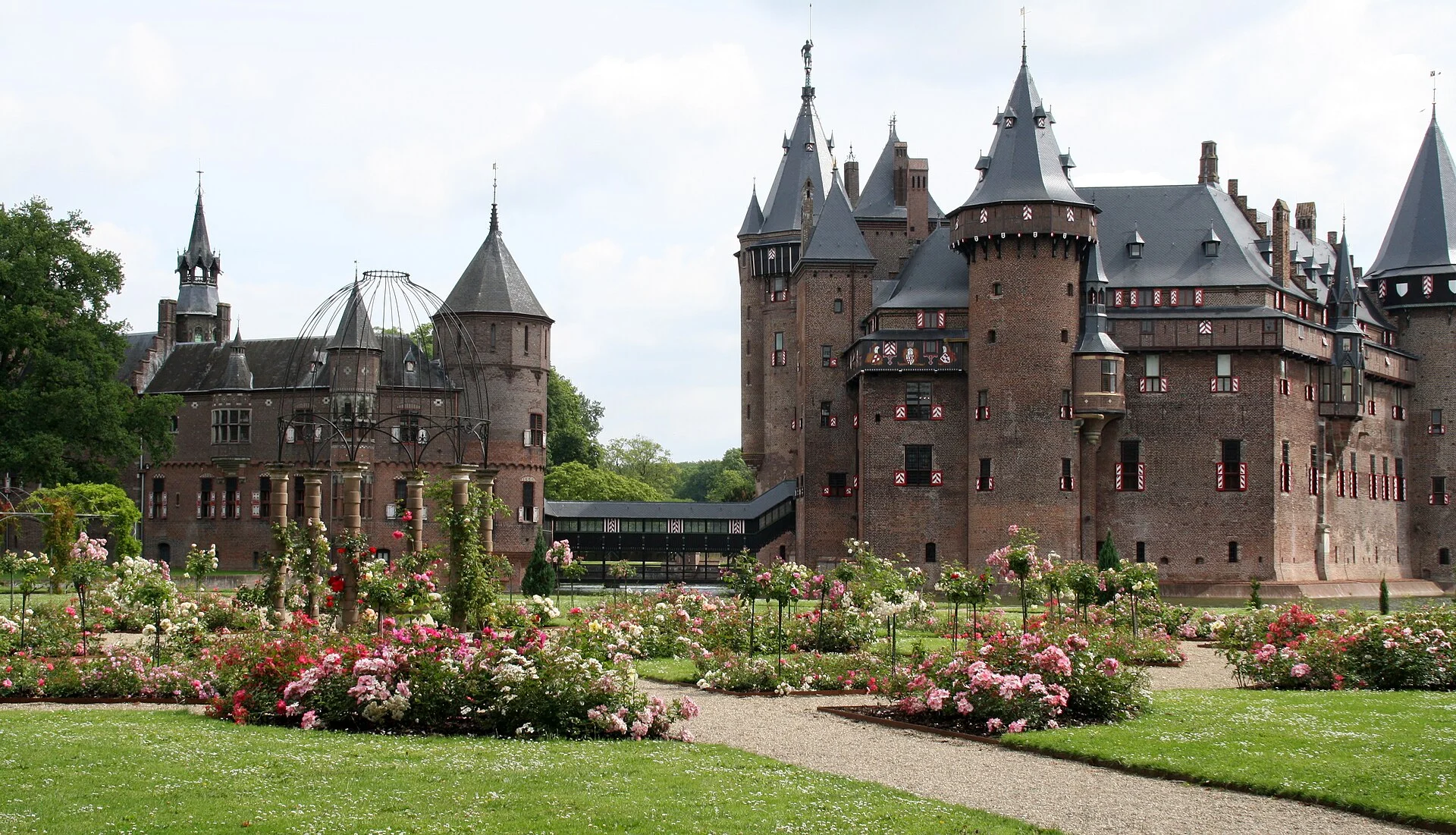 Kasteel de Haar reflected in its moat beside formal gardens