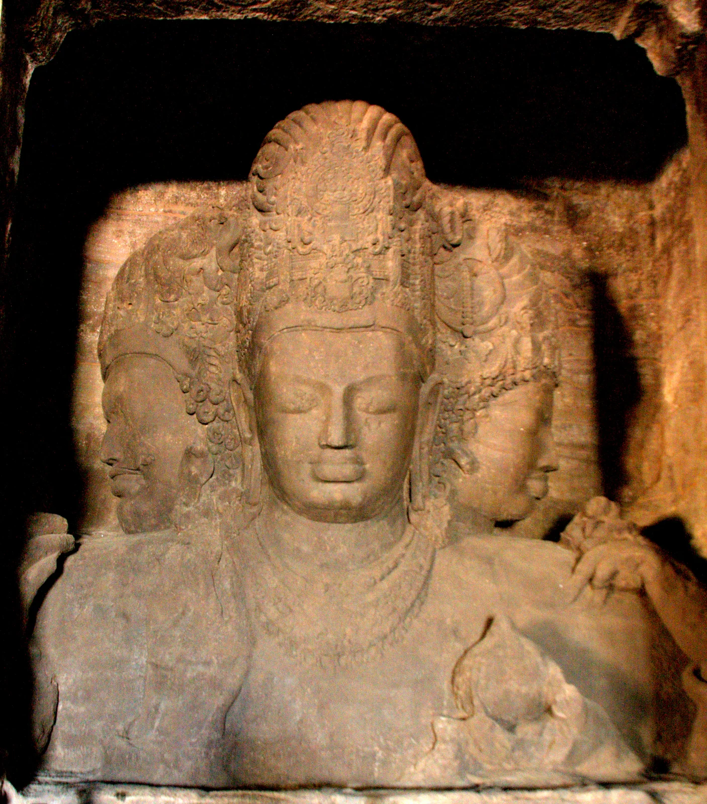The three-headed Trimurti Shiva sculpture carved from rock at the Elephanta Caves