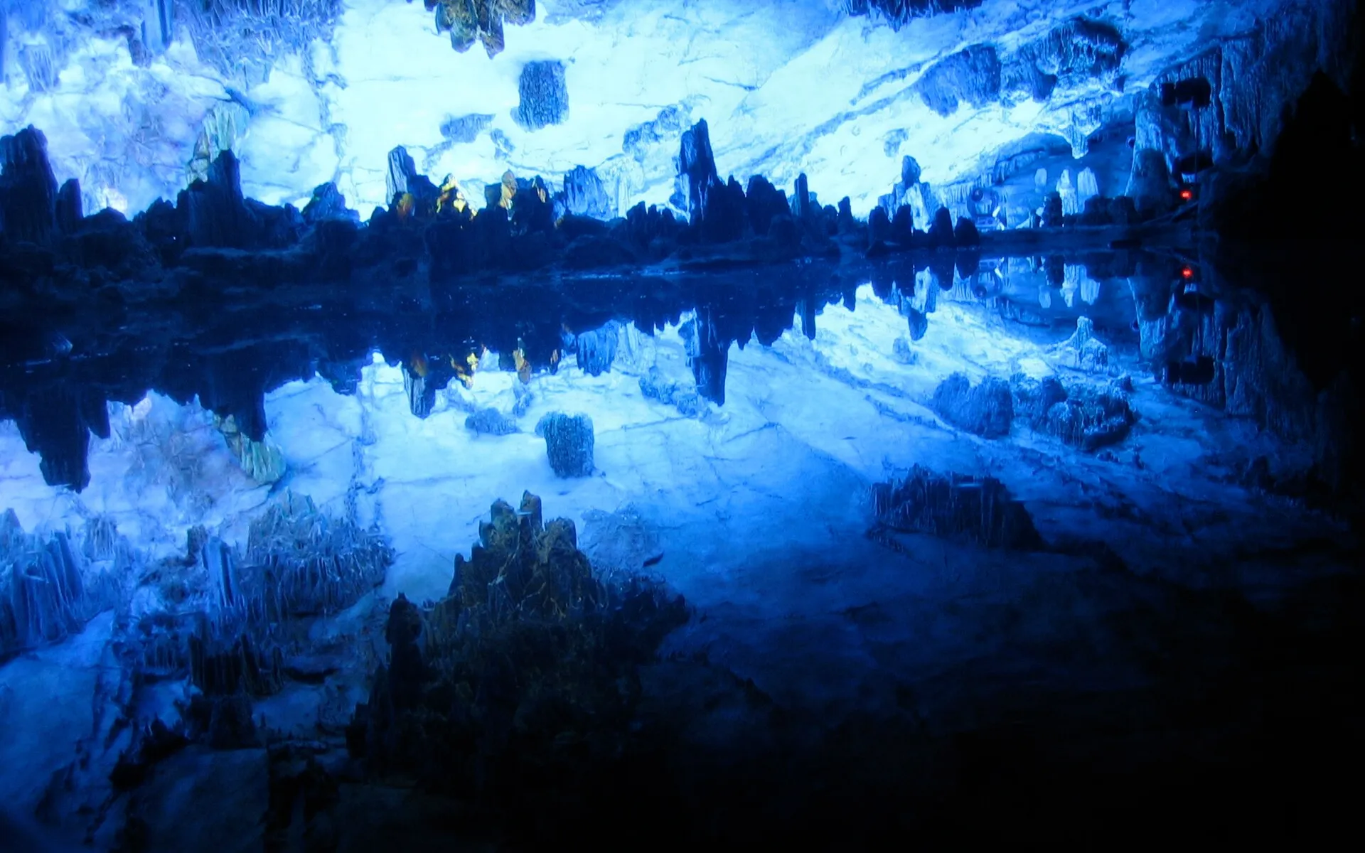 Colorfully illuminated stalactites inside Reed Flute Cave in Guilin